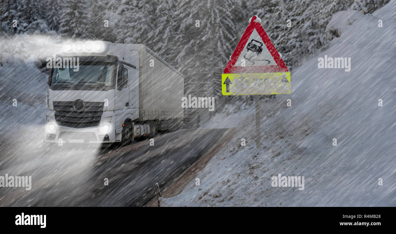 Truck is driving on the road in winter with snow and ice Stock Photo