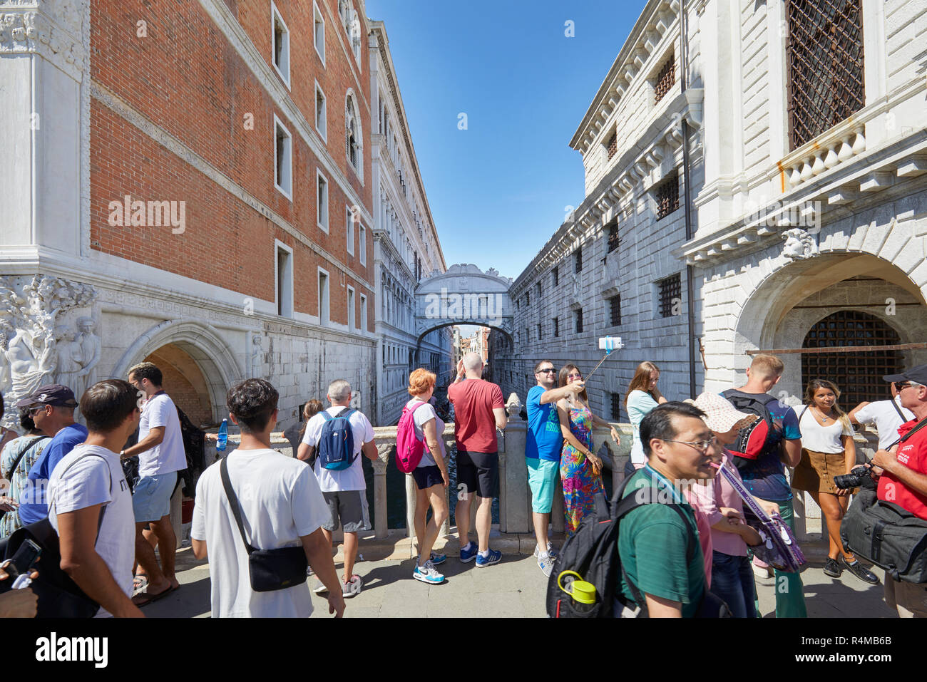 VENICE, ITALY - AUGUST 13, 2017: Bridge of Sighs people and tourists passing and shooting photos to the famous bridge in a sunny summer day in Venice, Stock Photo