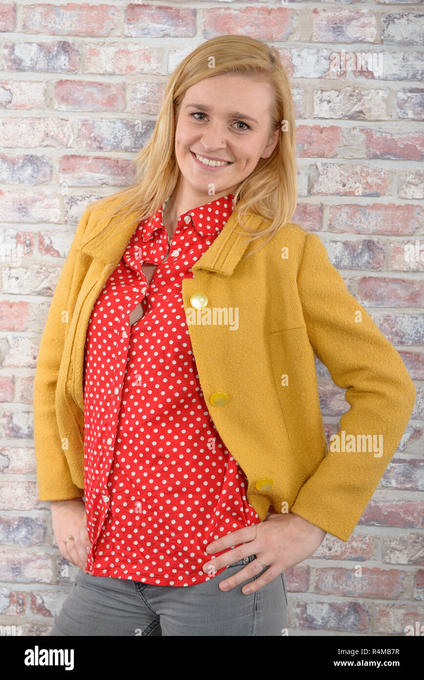 beautiful young woman with a yellow jacket Stock Photo - Alamy