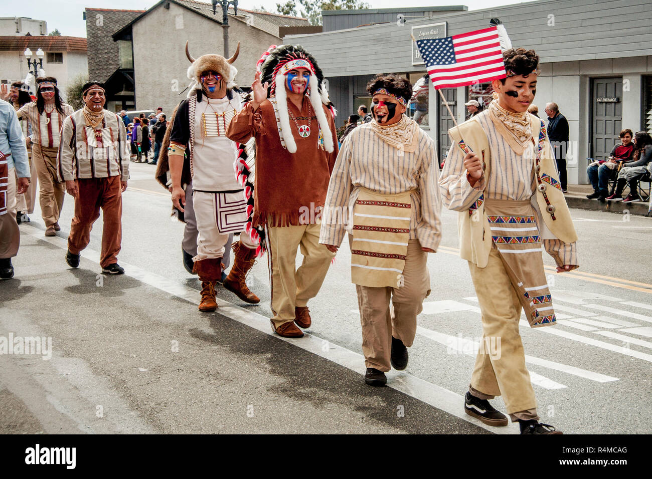 Wearing traditional clothing, a Native American contingent of Buffalo Bill's Wild West and Congress of Rough Riders of the World proudly carries the US flag during a Memorial Day festival in Laguna Beach, CA. Stock Photo