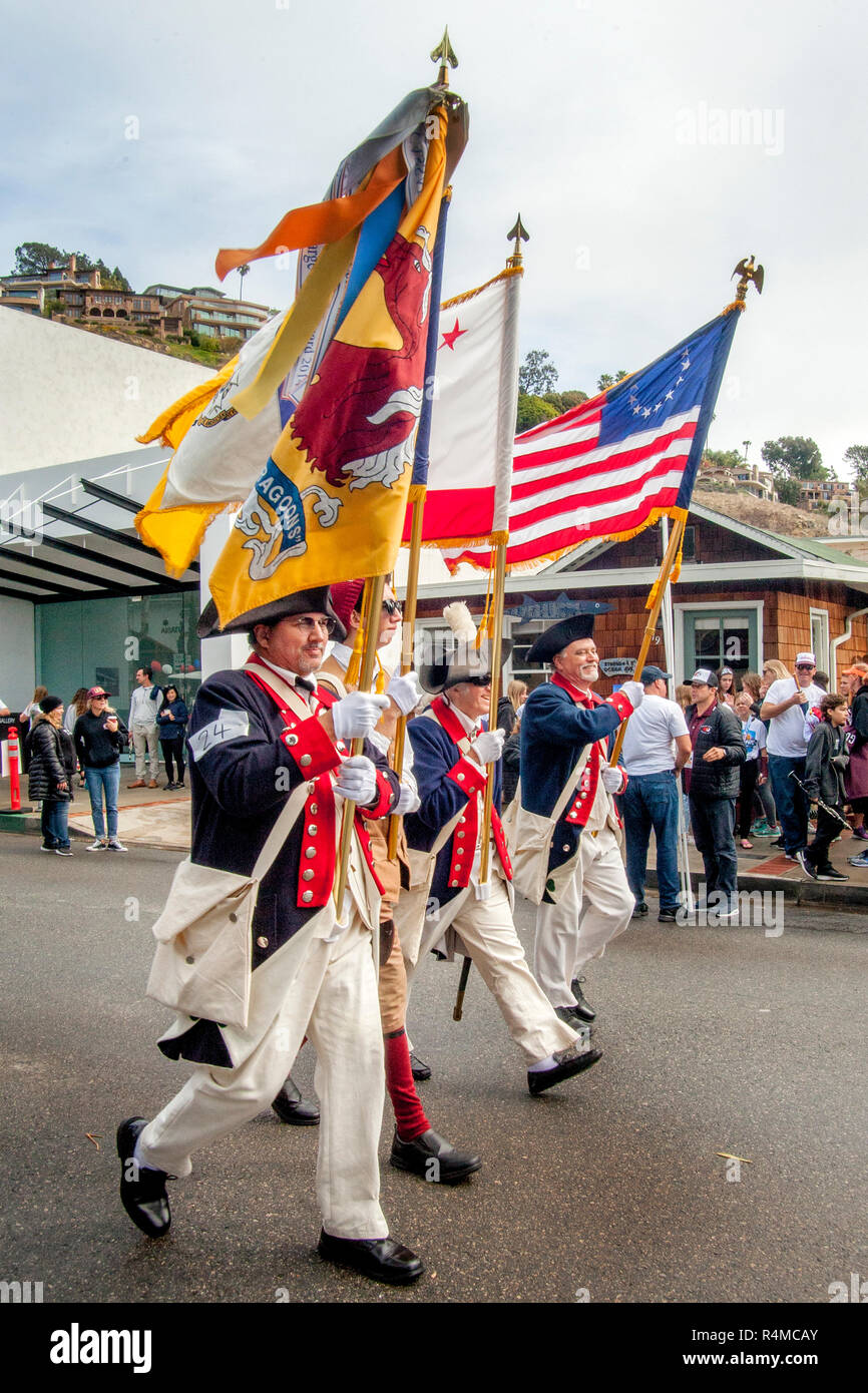 Period-costumed members of the Sons of the American Revolution march beneath billowing banners at a Memorial Day parade in Laguna Beach, CA.  (Photo by Spencer Grant) Stock Photo