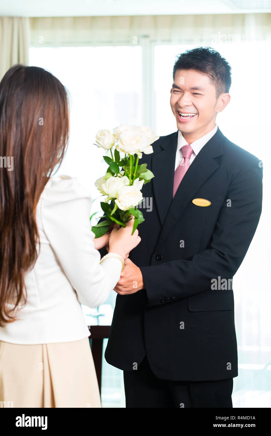 Hotel worker welcoming guests hi-res stock photography and images - Alamy