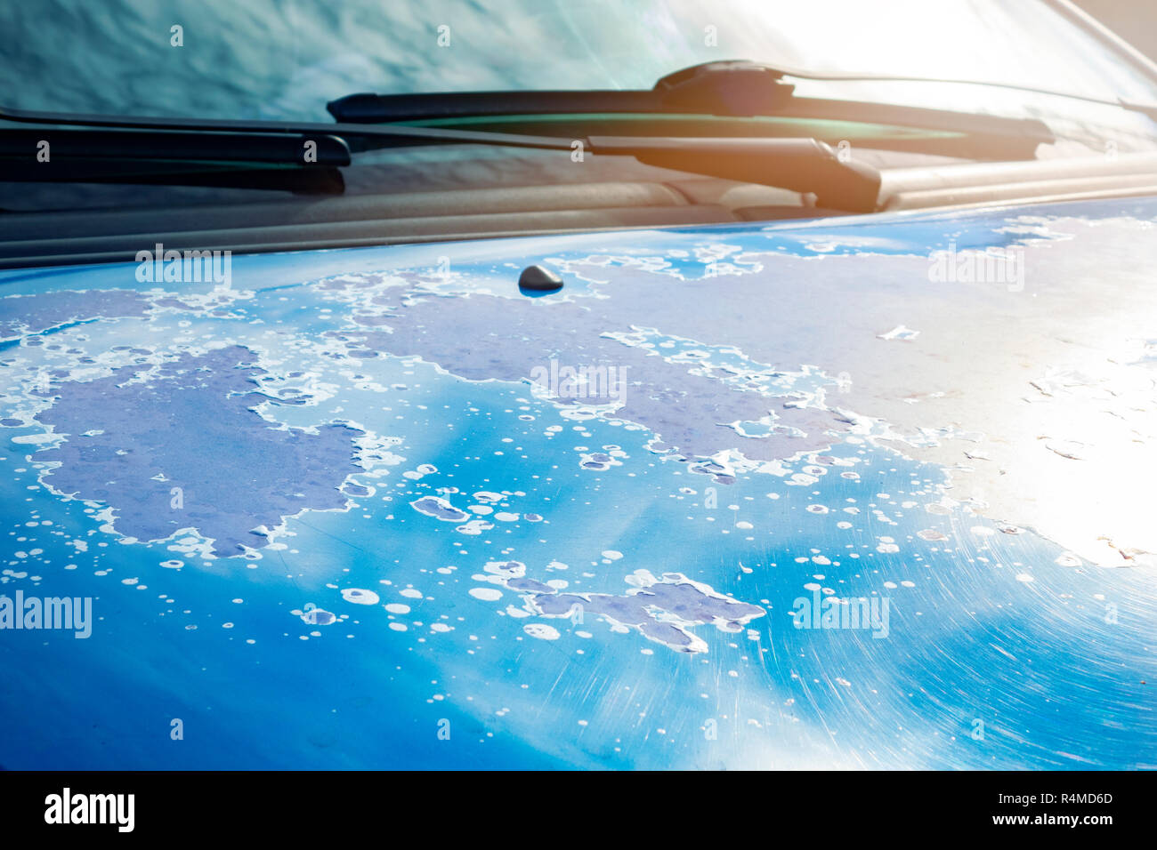 The surface of the body of an modern car. Cracked paint on car bodywork