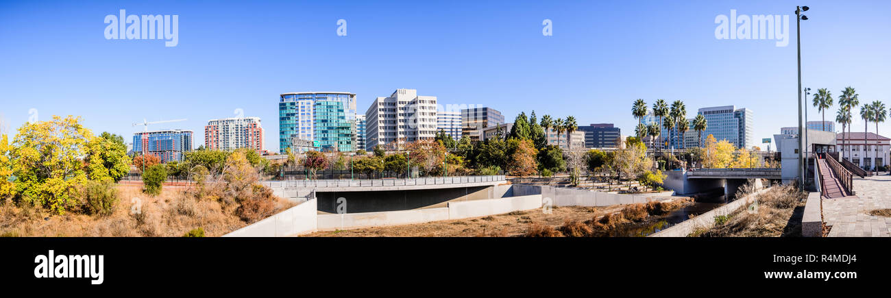 Panoramic view of San Jose's downtown skyline as seen from the shoreline of Guadalupe river on a sunny fall day; Silicon Valley, California Stock Photo