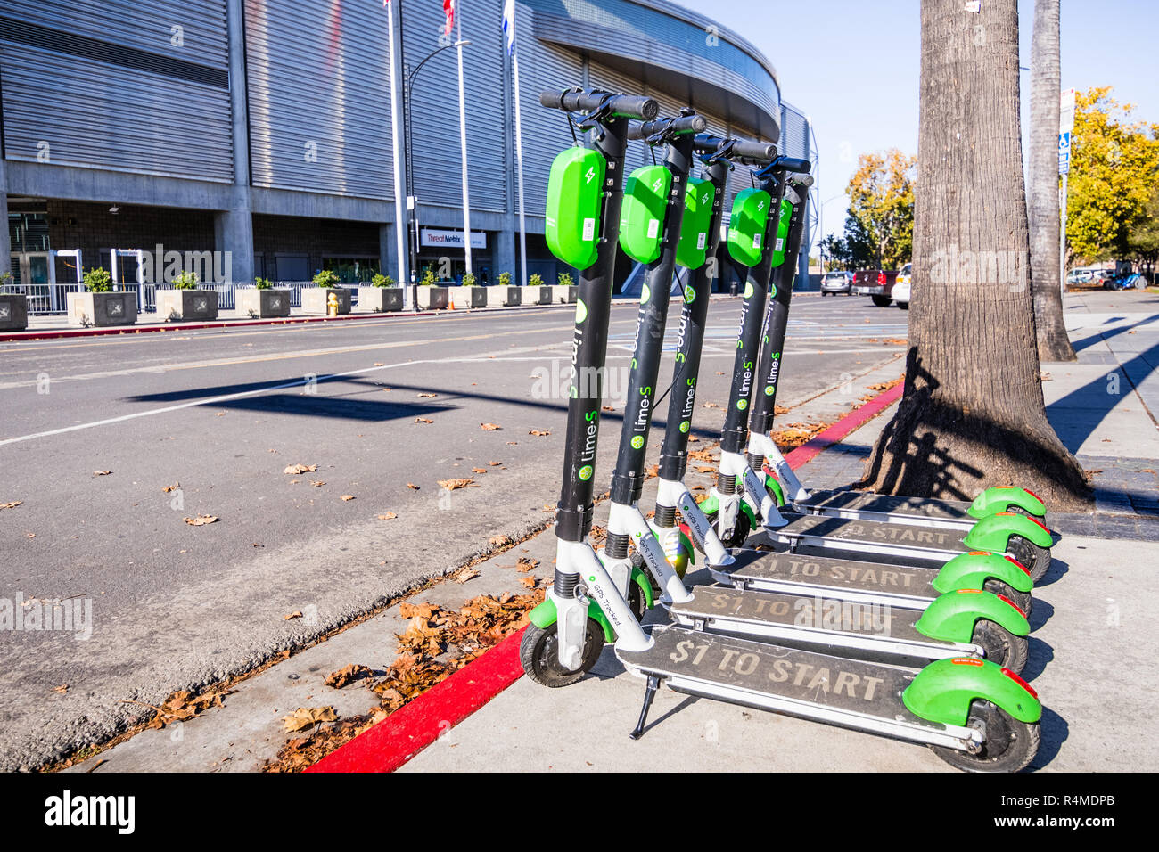 November 25, 2018 San Jose / CA / USA - Lime Scooters lined up on a sidewalk in downtown San Jose, south San Francisco bay area Stock Photo