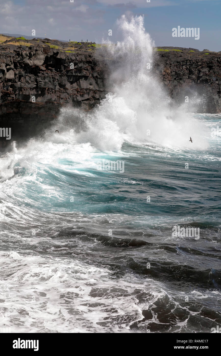 Hawaii Volcanoes National Park, Hawaii - Waves crash against cliffs lining the Pacific coast at the end of the Chain of Craters Road. Stock Photo