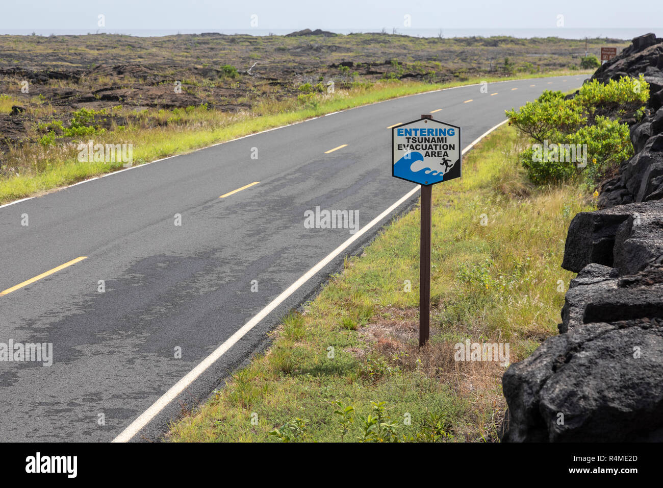 Hawaii Volcanoes National Park, Hawaii - A sign along the Chain of Craters Road near the Pacific Ocean designates a tsunami evacuation area. Stock Photo