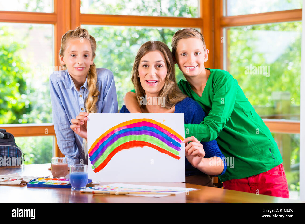 Mother with kids painting pictures Stock Photo