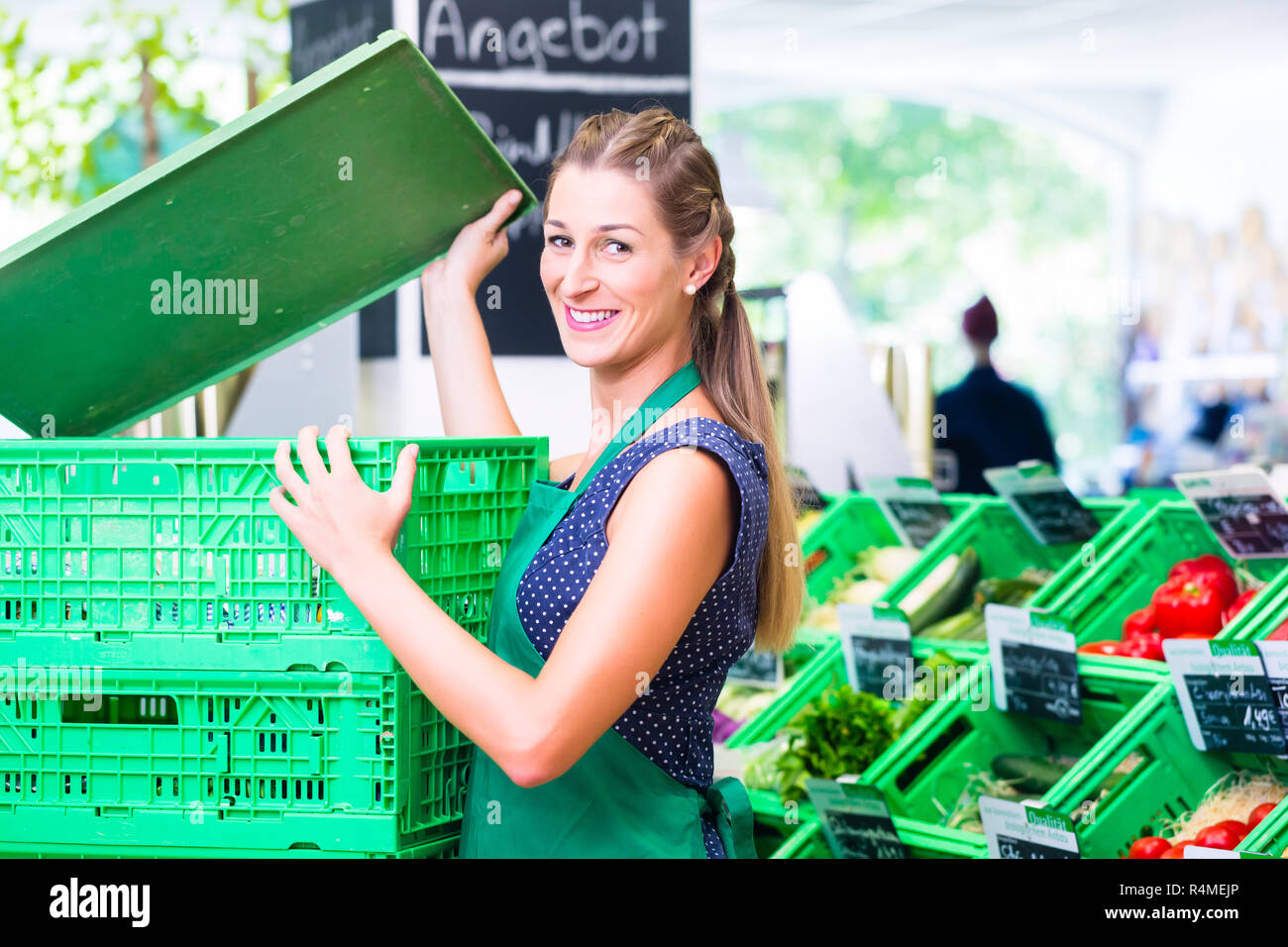 Corner shop clerk filling up storage racks Stock Photo Alamy