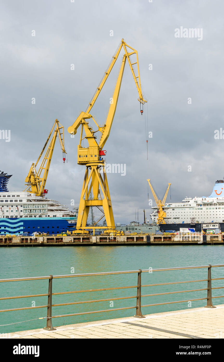 Cadiz, Spain -  November 2, 2018: Commercial port of Cadiz with rail cranes, containers and two ships of Tui Cruises under repair works  in the shipya Stock Photo