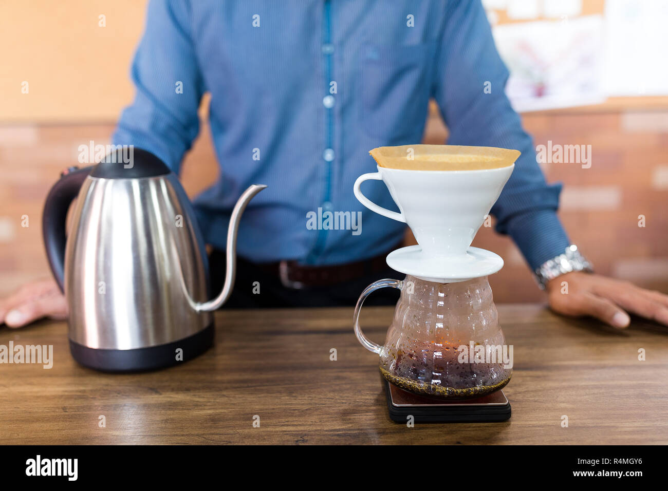 Male Barista making of coffee in cafe Stock Photo
