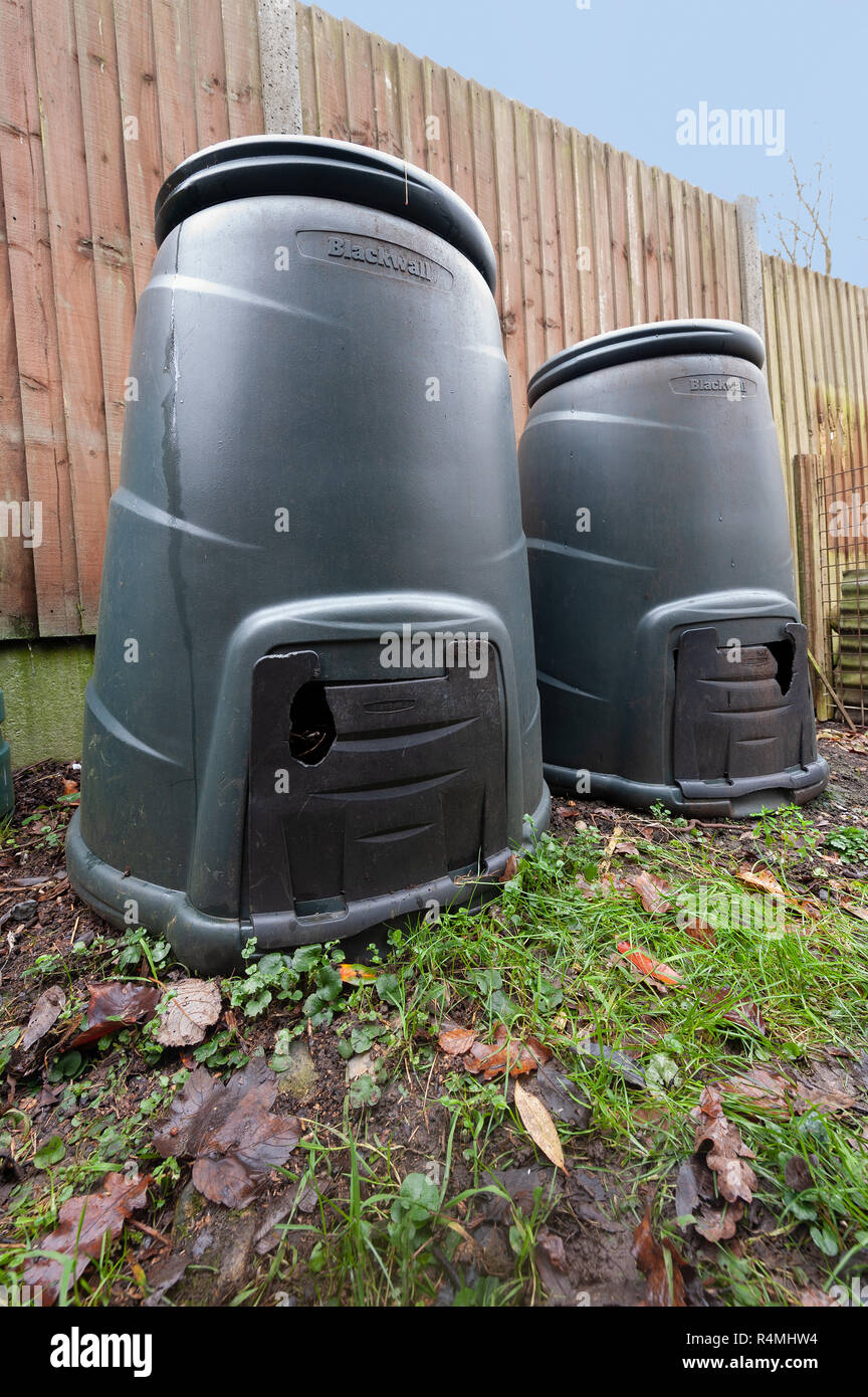 Desperate for food or shelter vermin rat squirrel have nibbled holes on the plastic door flap of a food, garden waste compost bin to gain entrance Stock Photo