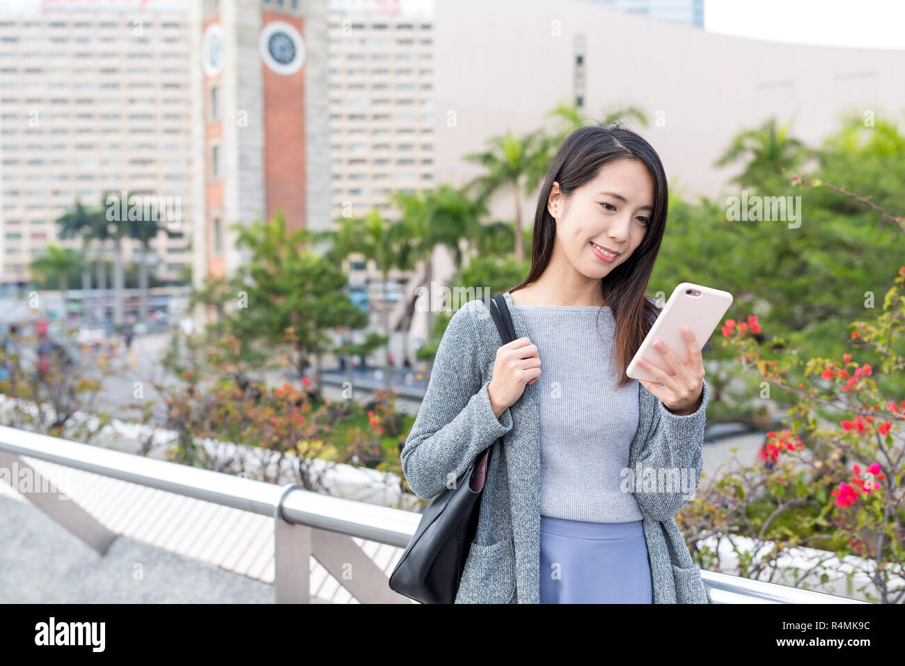 Woman working on mobile phone in Hong Kong Stock Photo - Alamy