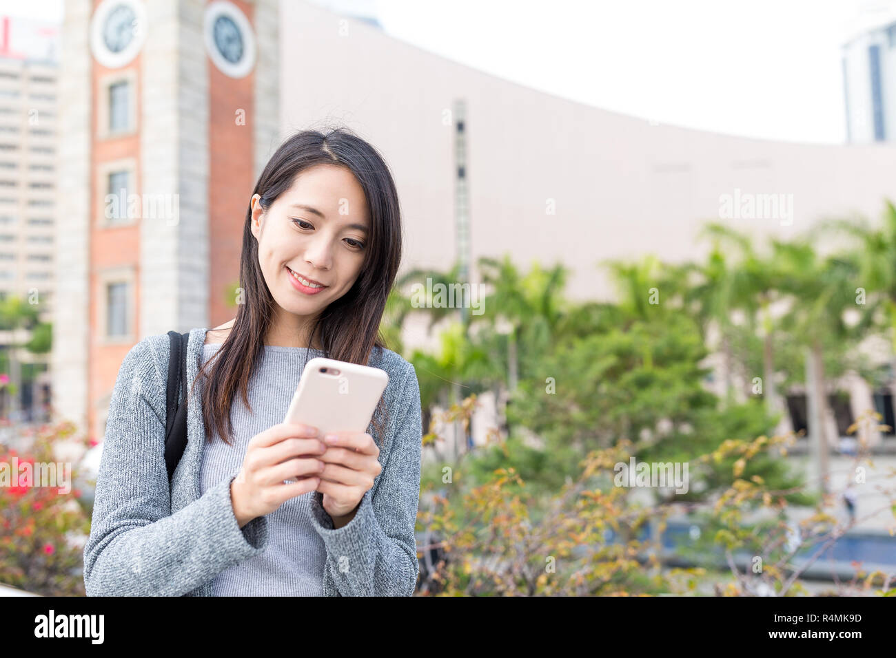 Woman using cellphone in Hong Kong Stock Photo - Alamy