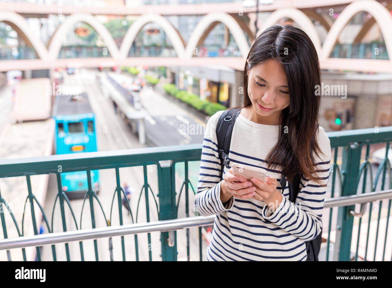 Woman using mobile phone in hong kong city Stock Photo - Alamy