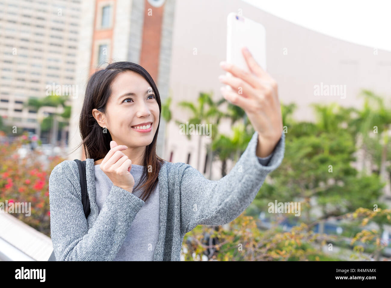 Woman taking selfie by mobile phone in Hong Kong Stock Photo - Alamy