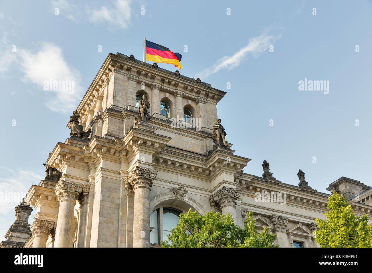 Closeup view of famous Reichstag building tower with German flag, seat of the German Parliament. Berlin Mitte district, Germany. Stock Photo