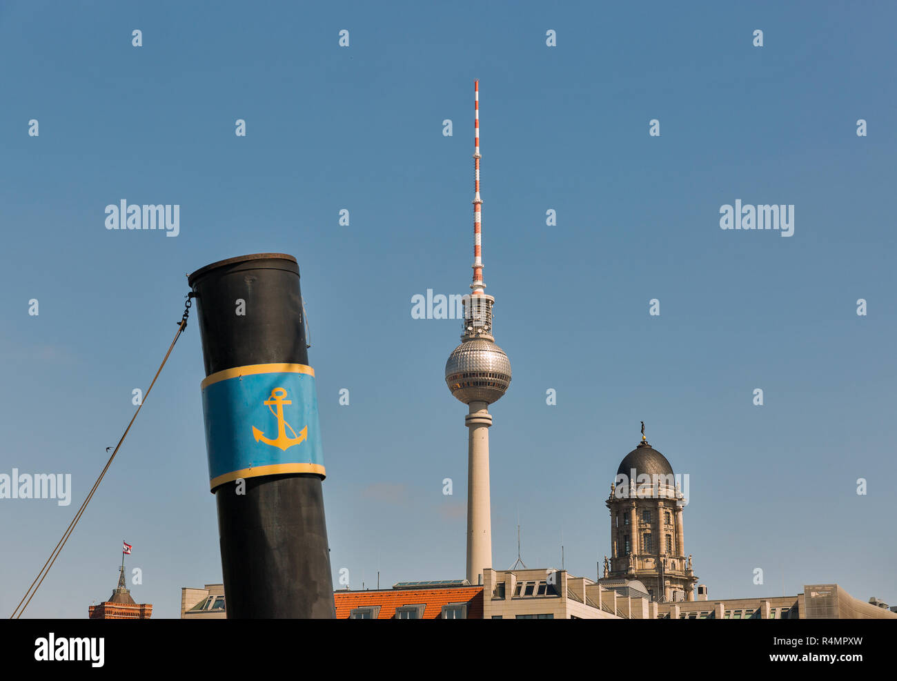 Berlin skyline with television tower, Judenhof or Jewish courtyard and ship pipe in foreground against clear blue sky, Germany. Stock Photo