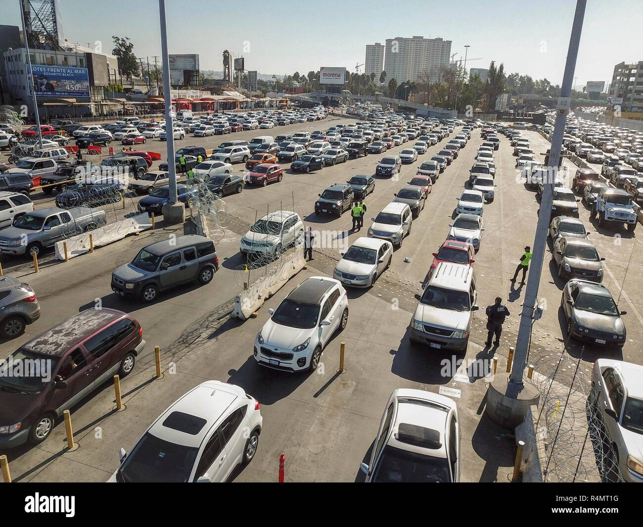 Vehicles line up at the border into the United States from Mexico as Customs and Border Patrol shut it down at the San Ysidro crossing after members of the migrant caravan attempted to illegally cross November 26, 2018 in San Ysidro, California. Stock Photo