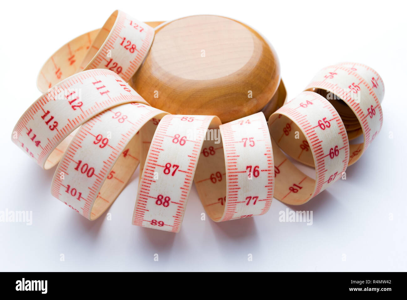 Yoyo effect in diet concept. Wooden yoyo with centimeter measure