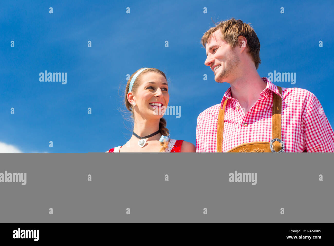 Couple visiting Bavarian fair having fun Stock Photo