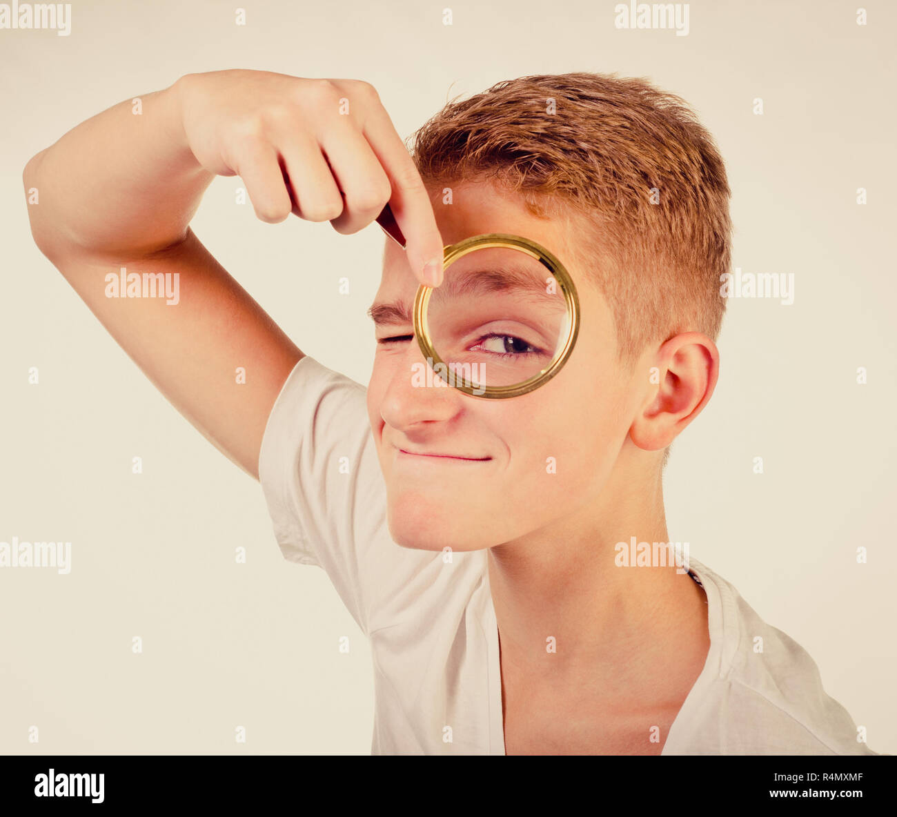 funny teenage boy with magnifier Stock Photo