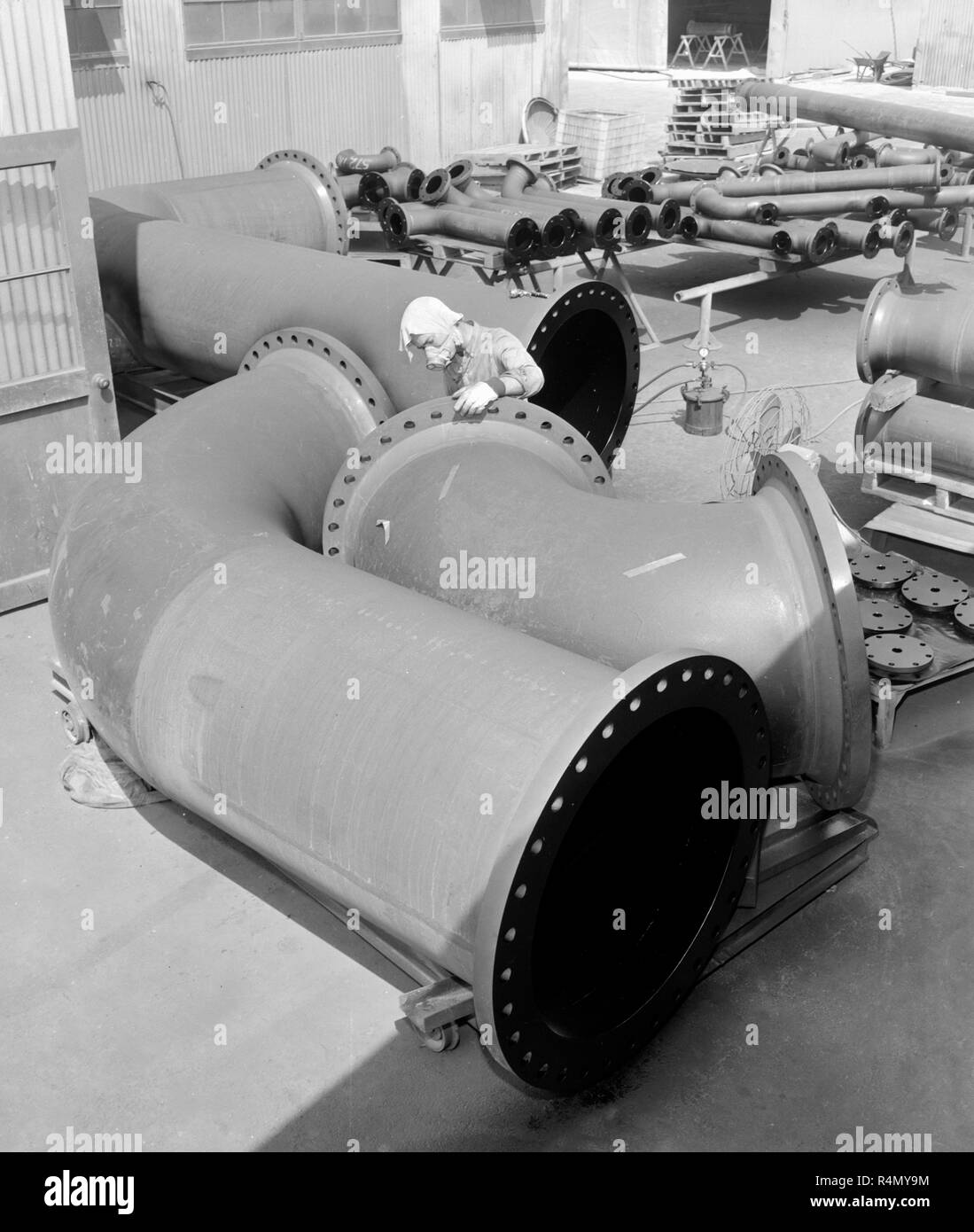 Workers at  pipe factory in California, ca. 1965. Stock Photo