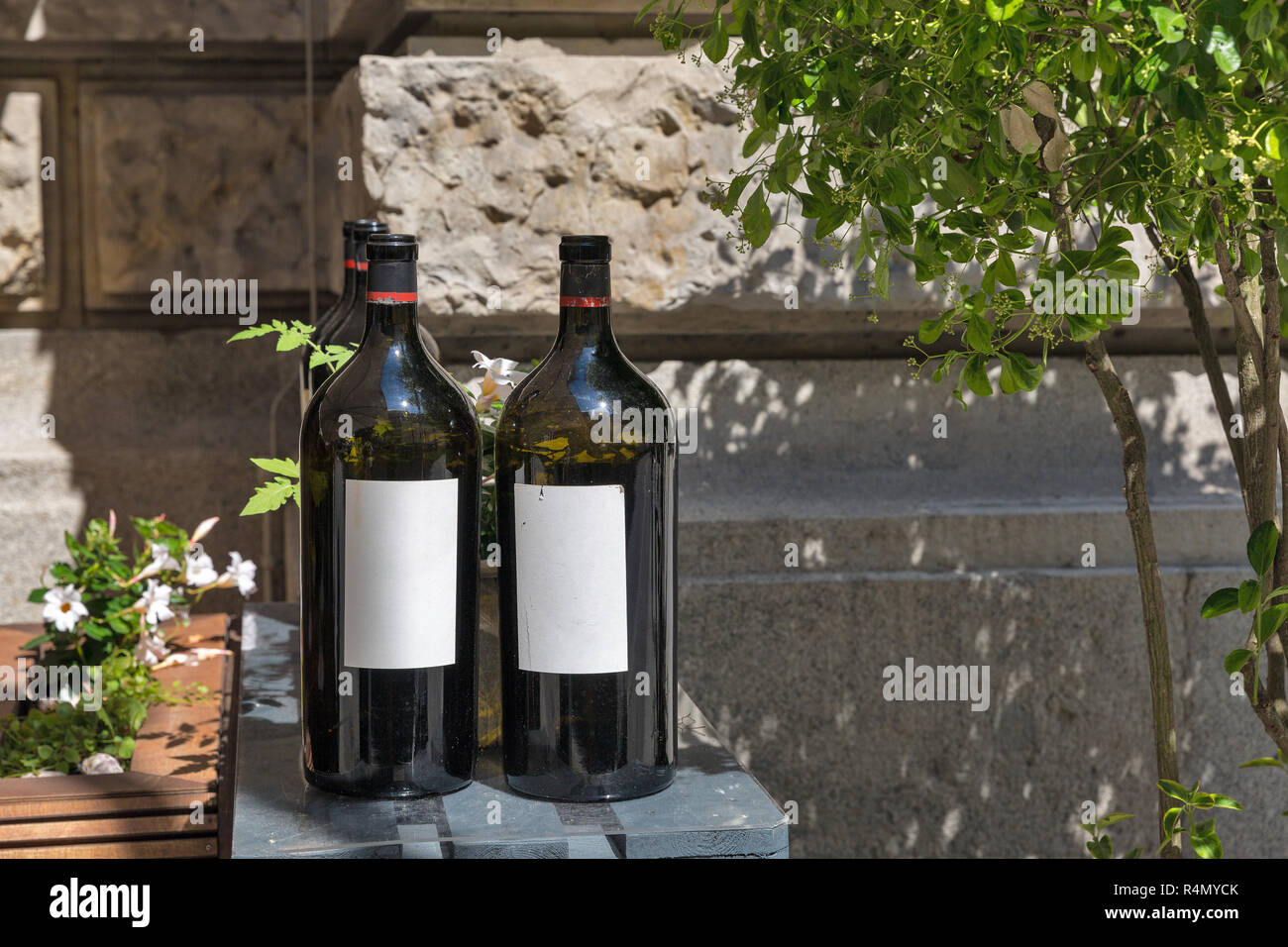 Wine bottles outdoor at sunny summer day in the city Stock Photo