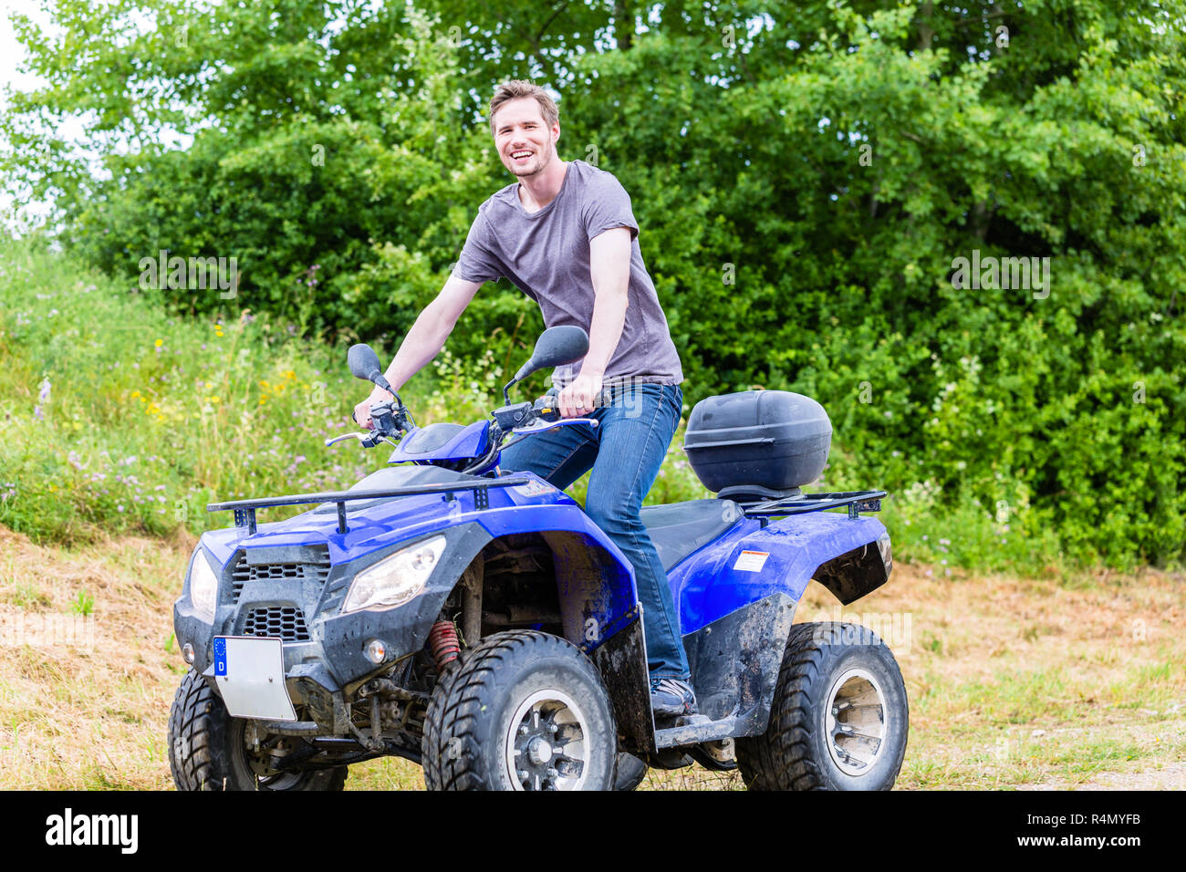 Man driving off-road with quad bike or ATV Stock Photo - Alamy