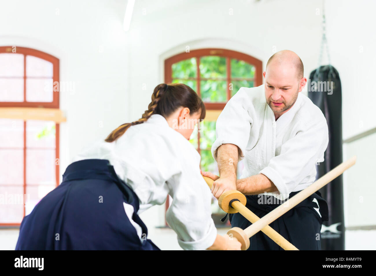 Man and woman having Aikido sword fight Stock Photo Alamy