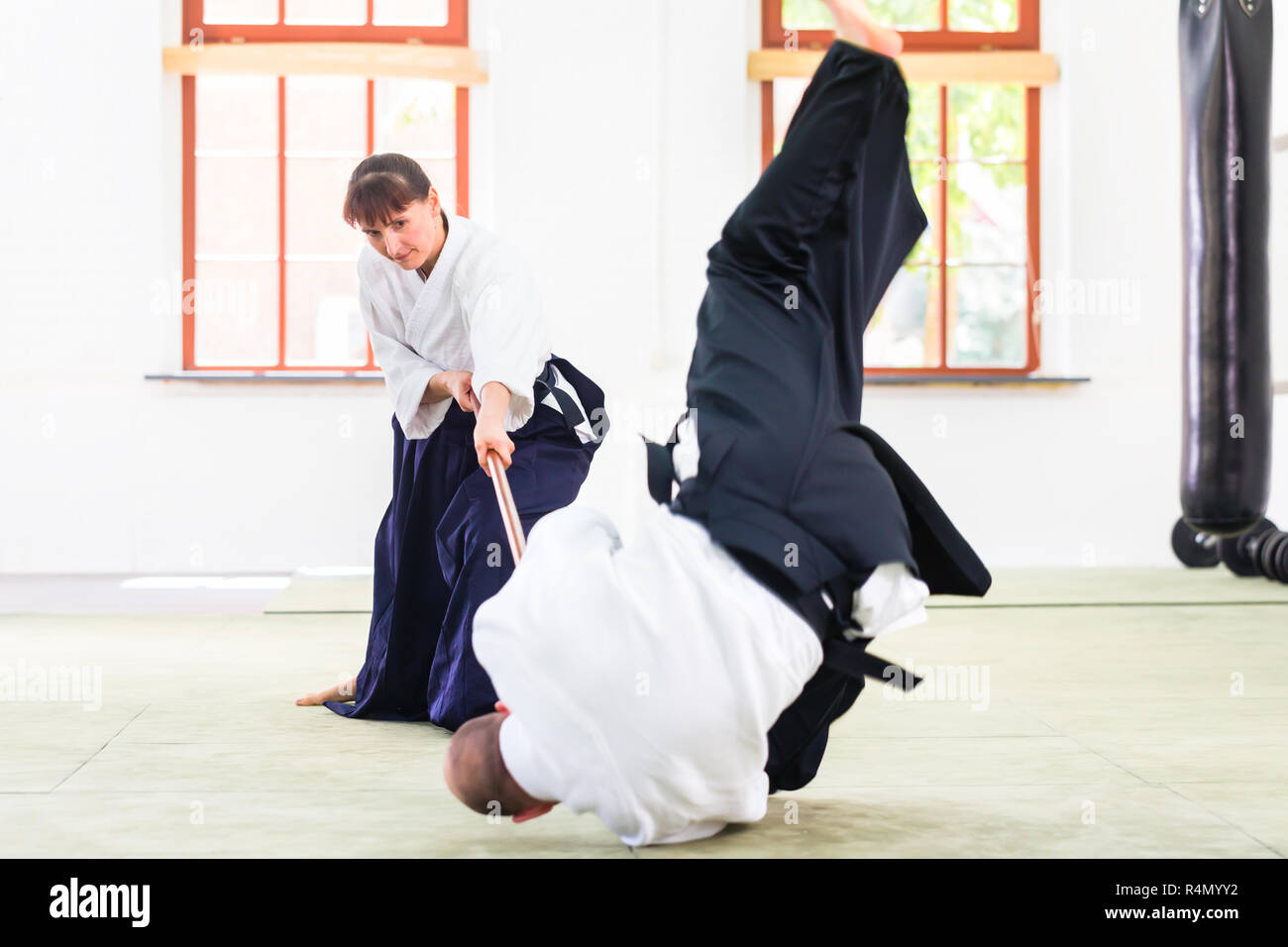 Man and woman having Aikido stick fight Stock Photo Alamy