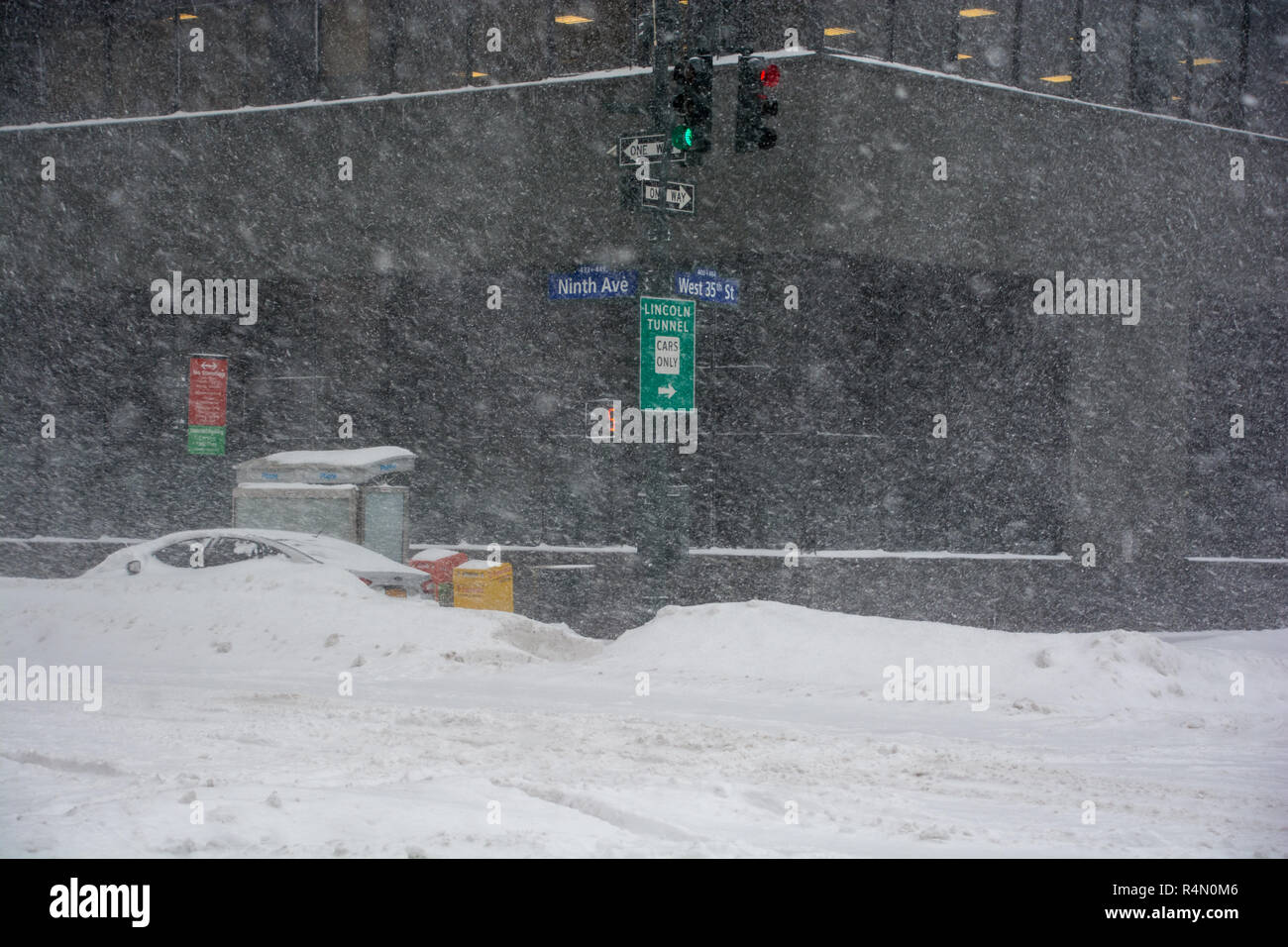 New York City streets in the blizzard of 23rd January 2016 with heavy snowfall and no traffic and snow covered car Stock Photo