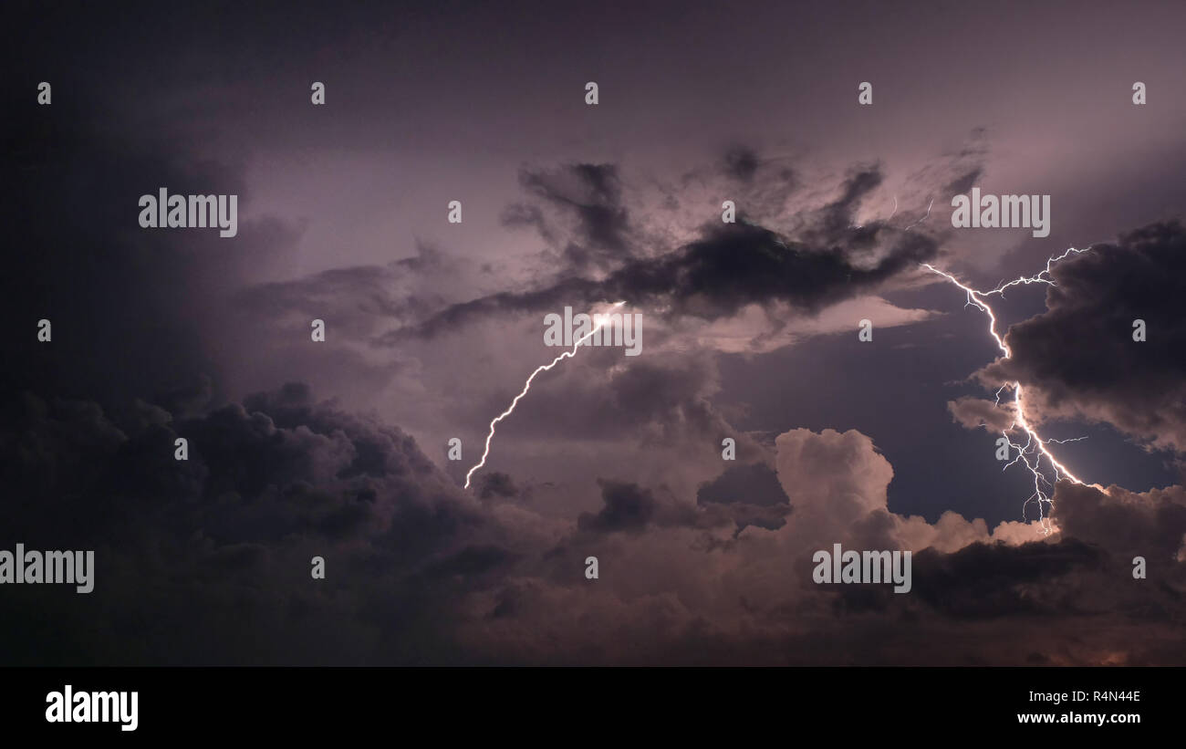 Lightning and storm clouds in sky Stock Photo