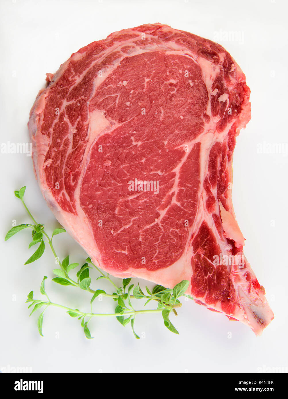 Raw steak and oregano Stock Photo Alamy