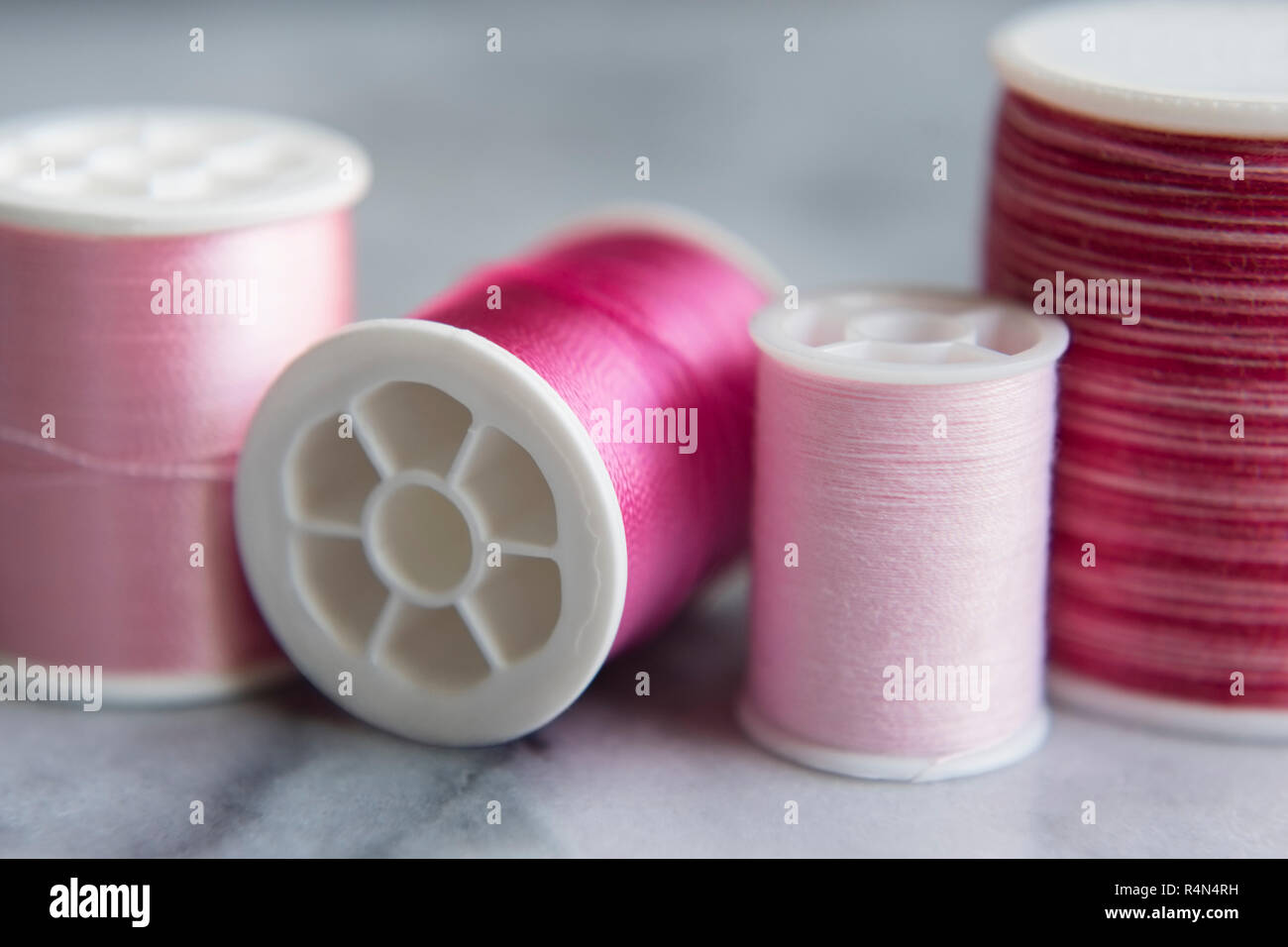 Variety of pink spools of thread Stock Photo Alamy