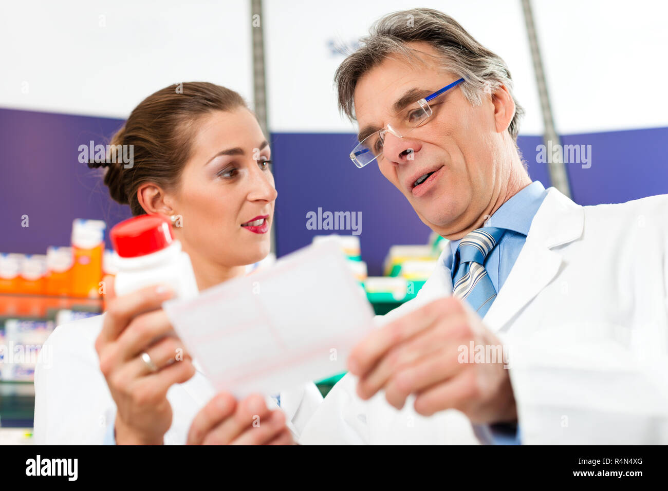 Two pharmacists in pharmacy consulting Stock Photo