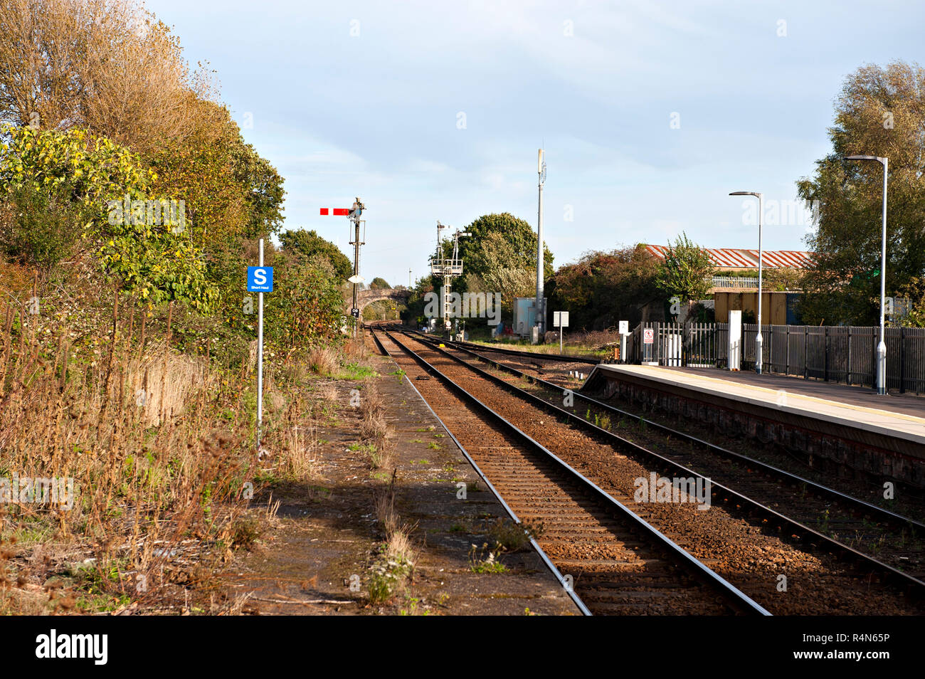 Oulton Broad North Railway Station, Suffolk, Looking east showing an unused and weed bound platform. Stock Photo