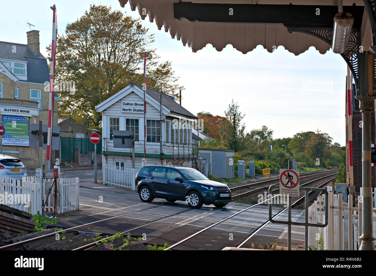 Oulton Broad North Signal Box and crossing, Suffolk, Barriers are up to allow road traffic to cross. Stock Photo