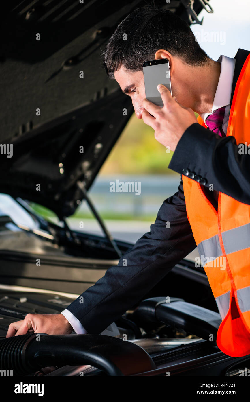 Man with car engine problems calling repair service Stock Photo - Alamy