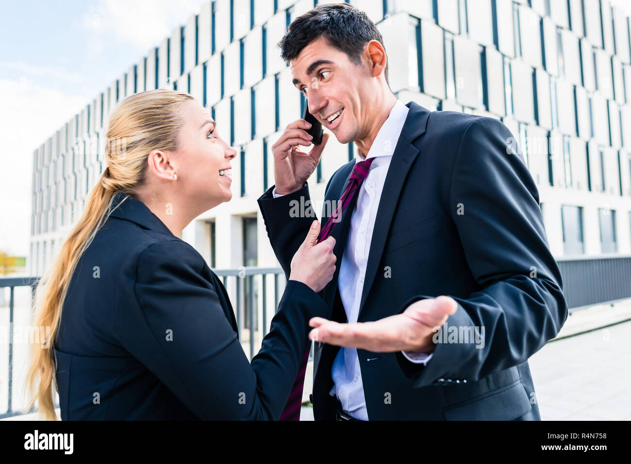 Flirt in the workplace woman teasing man Stock Photo Alamy