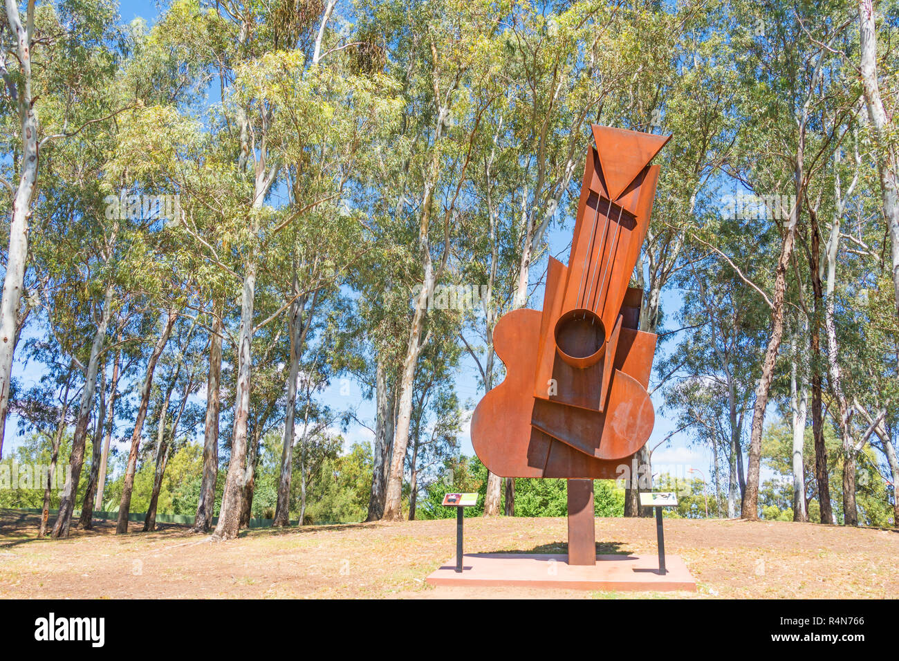A Corten Steel Picasso Guitar sculpture by Peter Hooper in 2016 on display in Tamworth Bicentennial Park NSW Australia. Stock Photo