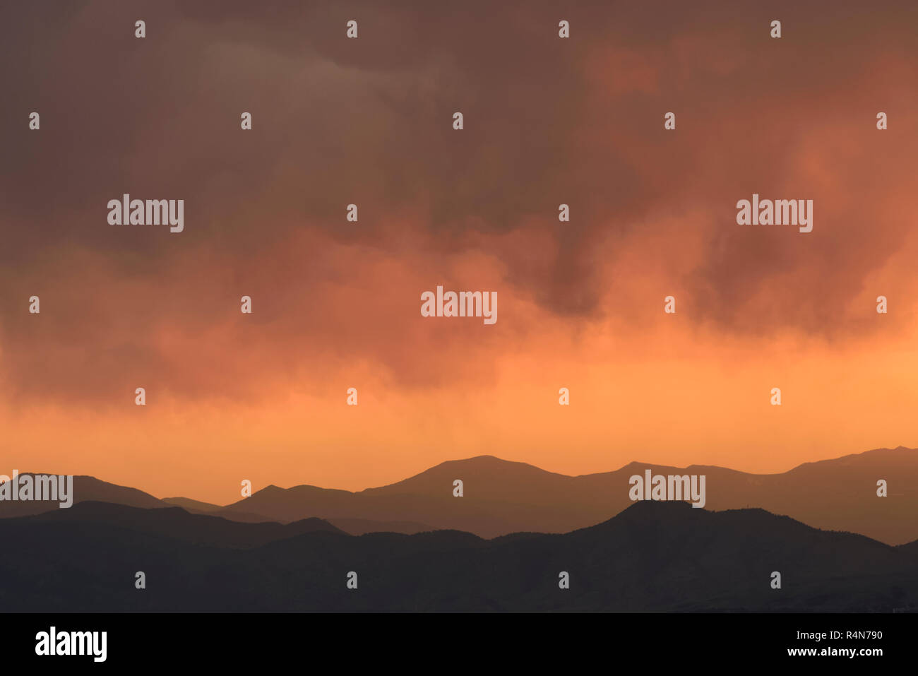 Distant wildfires and mountains at sunset in Denver, Colorado Stock Photo