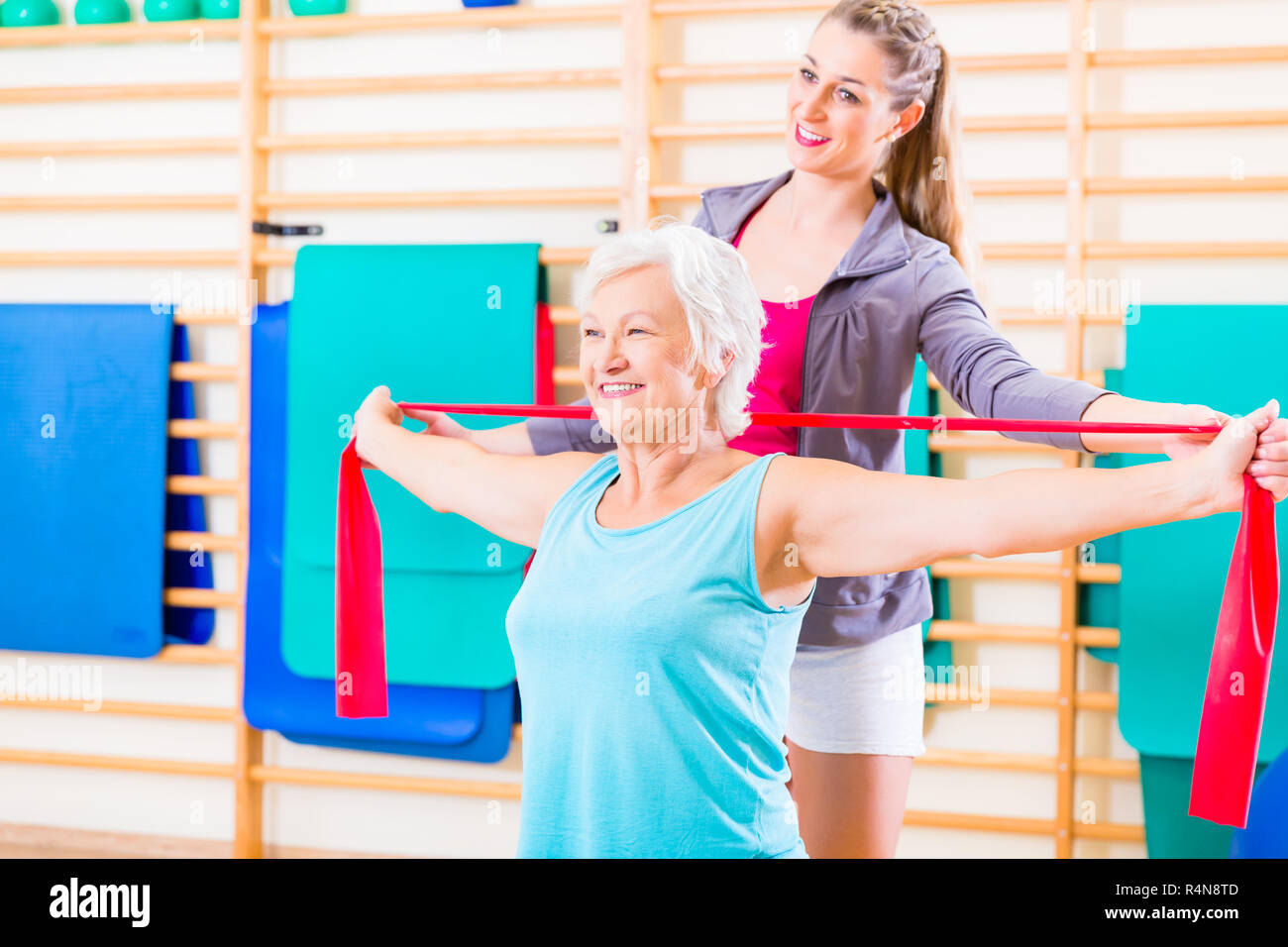 Senior woman with stretch band at fitness Stock Photo