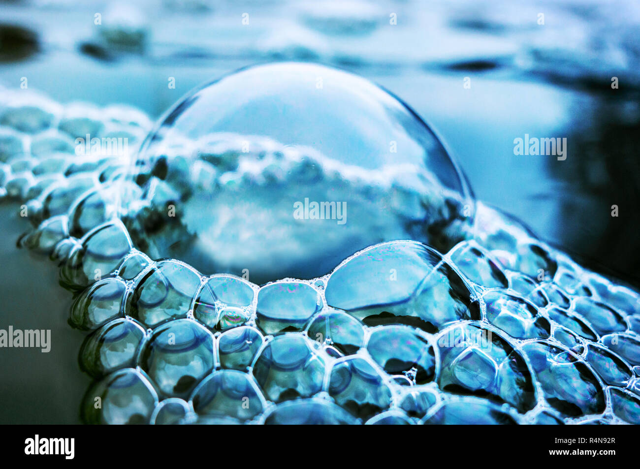 Closeup of a large bubble and a Cluster of bubbles made by a water fountain in an English garden