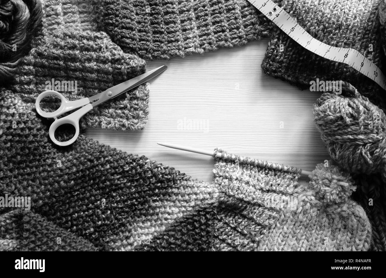 Border of knitting, wool, craft scissors and tape measure Stock Photo