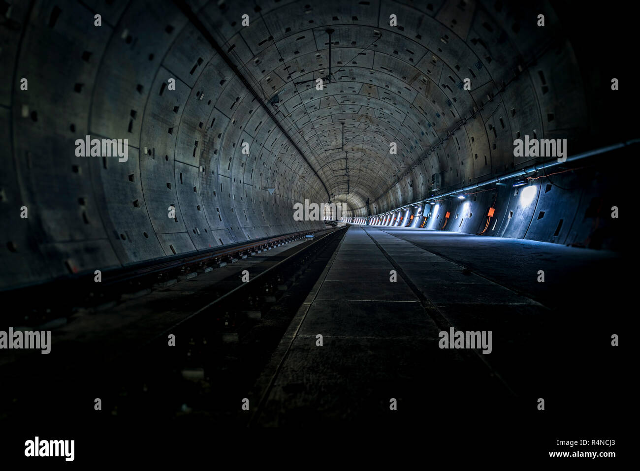 underground shaft with track and emergency lighting Stock Photo