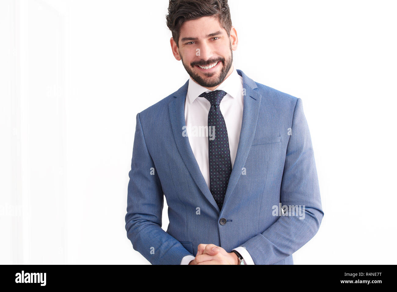 Portrait of smiling young professional businessman wearing suit and tie ...