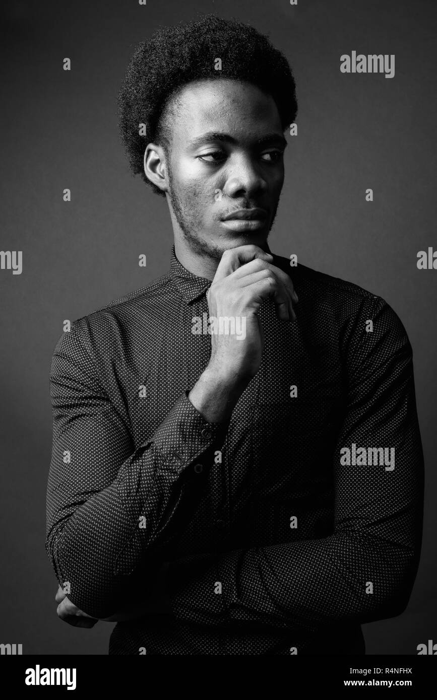 Black and white portrait of handsome African man thinking Stock Photo