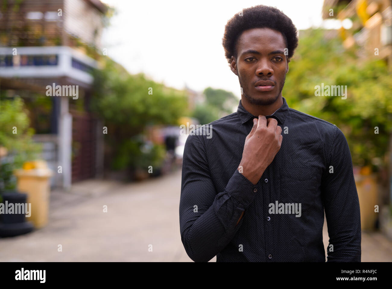 Young handsome African businessman in the streets outdoors Stock Photo