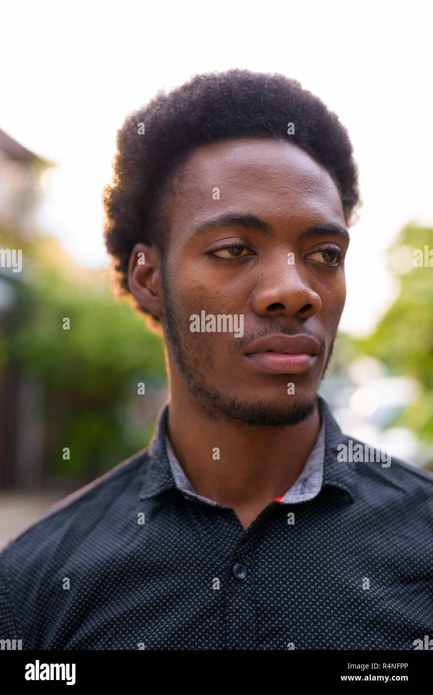 Face of young handsome African businessman outdoors Stock Photo